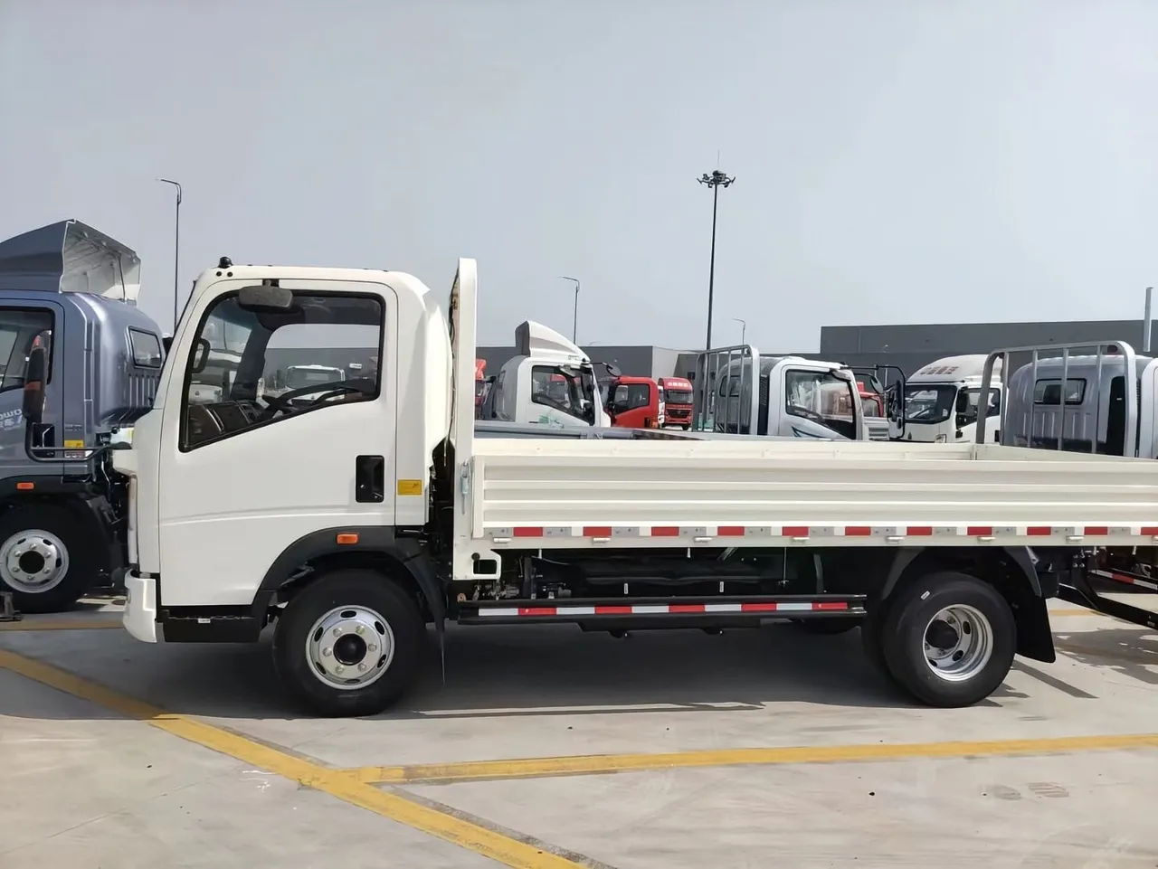 HOWO flatbed cargo truck loaded with building materials