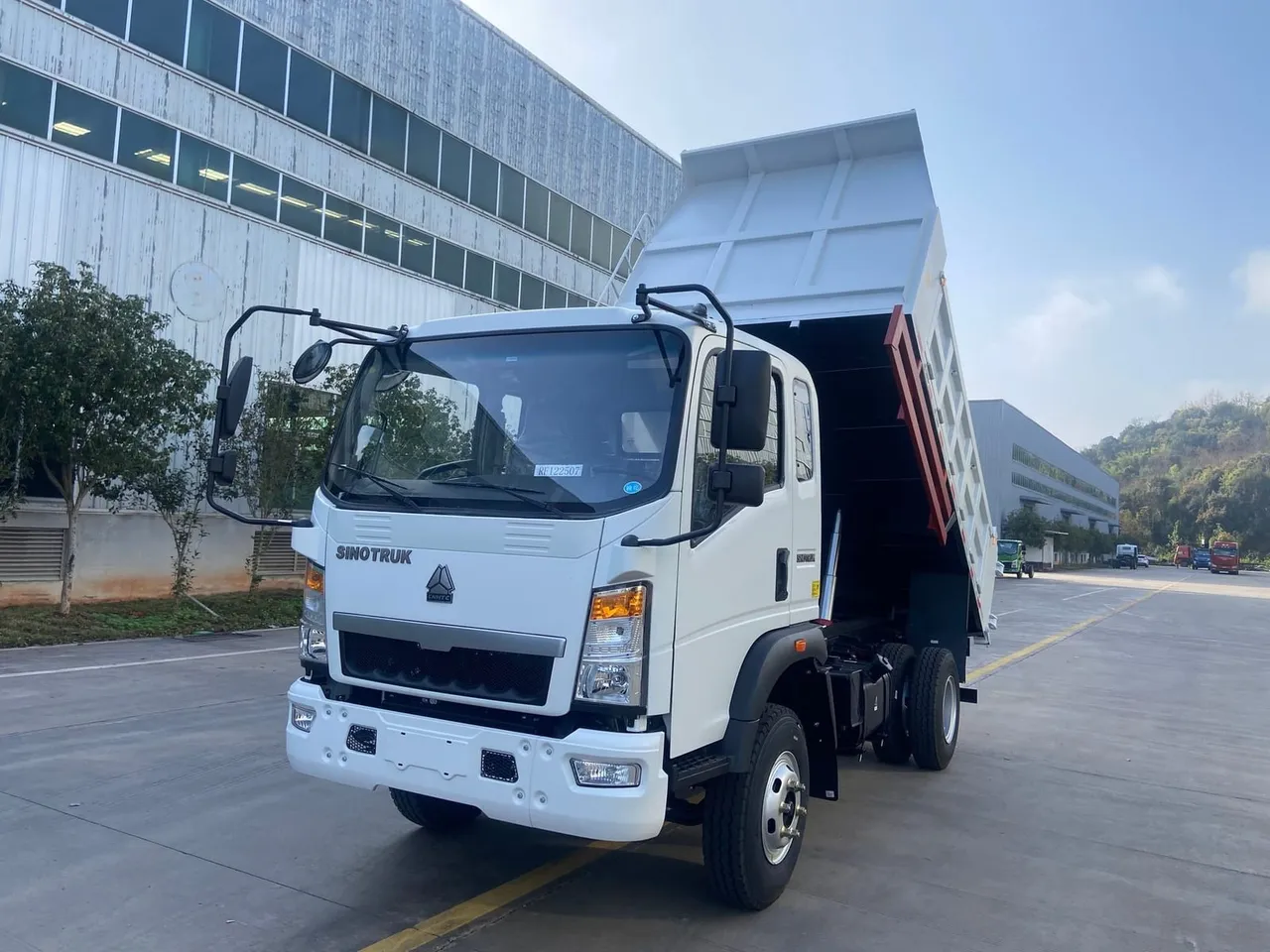 Used HOWO 4x2 mini dump truck on a narrow urban construction site in Africa