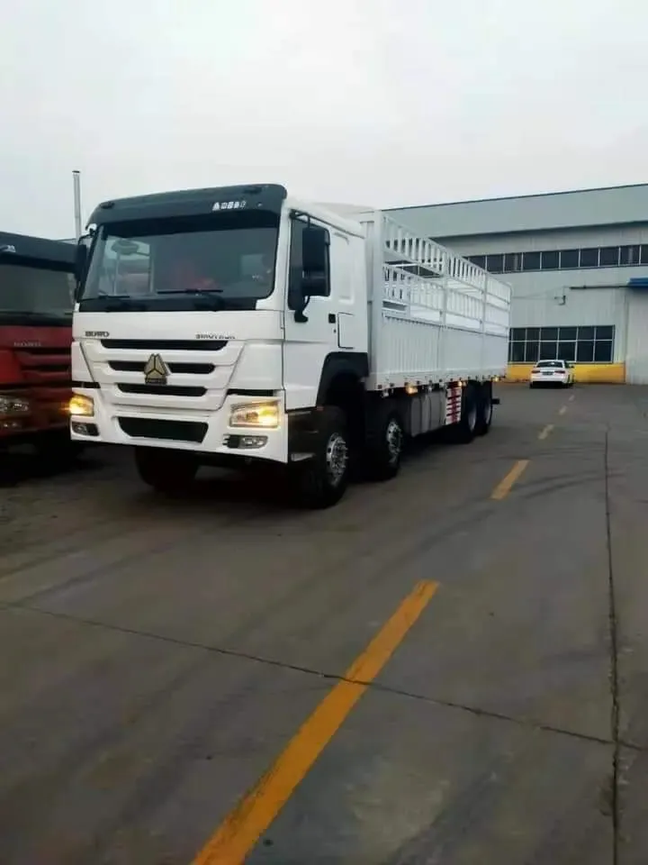 Used HOWO stake fence lorry with removable side rails loaded with cargo