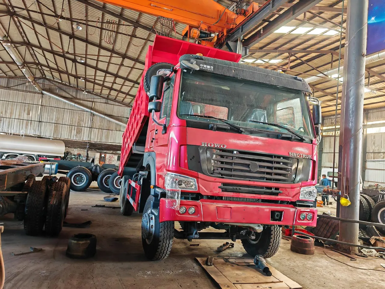 Used HOWO dump truck with raised tipper body, inspected and ready for export from China