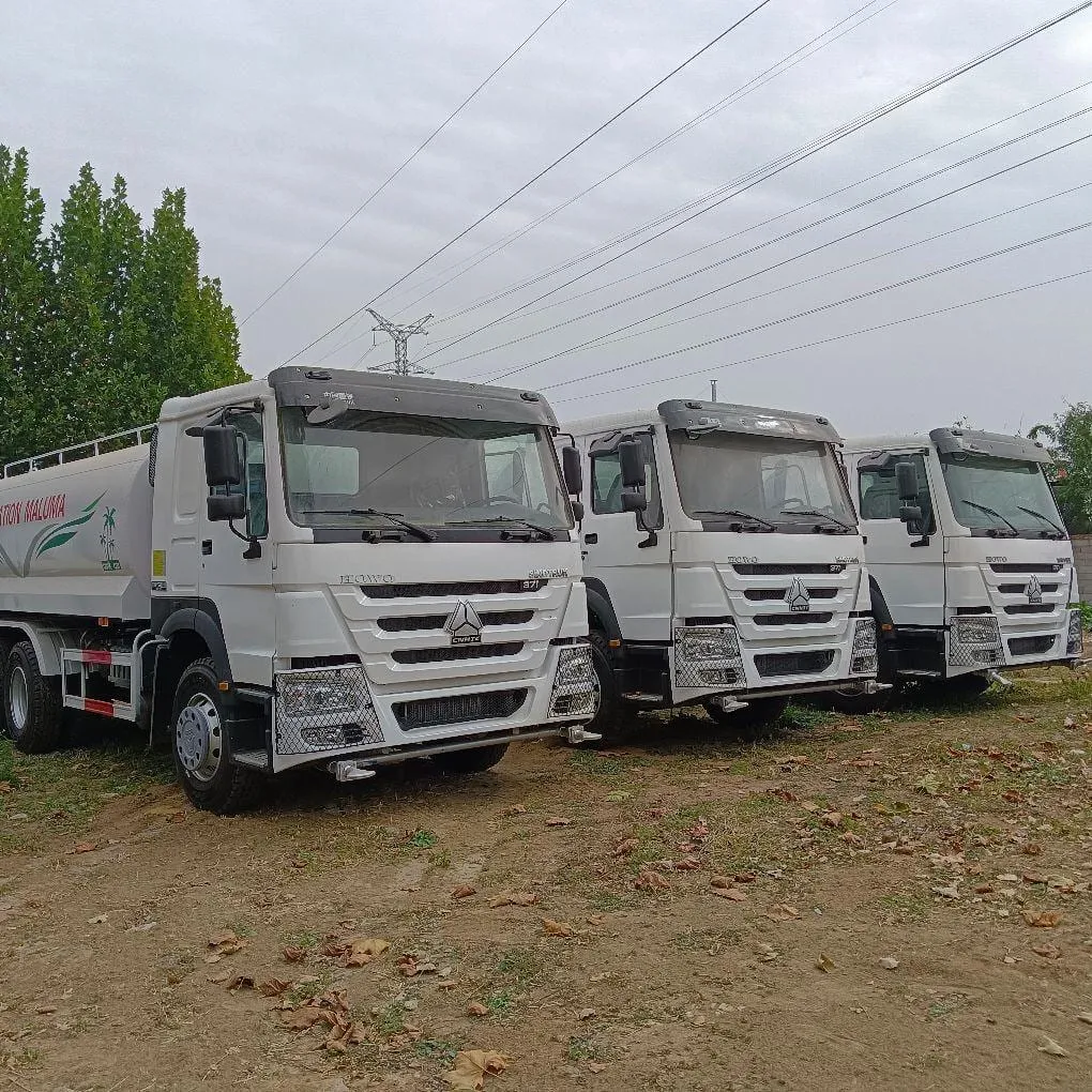 Used water bowser truck spraying road, construction site, East Africa