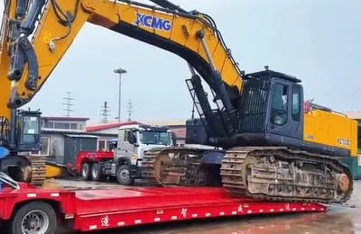 Used Chinese semi-trailer trucks lined up at yard — lowbed, flatbed and container chassis trailers ready for export