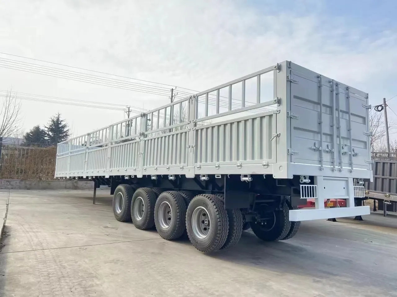 Used side tipper semi-trailer dumping bulk material on mine haul road