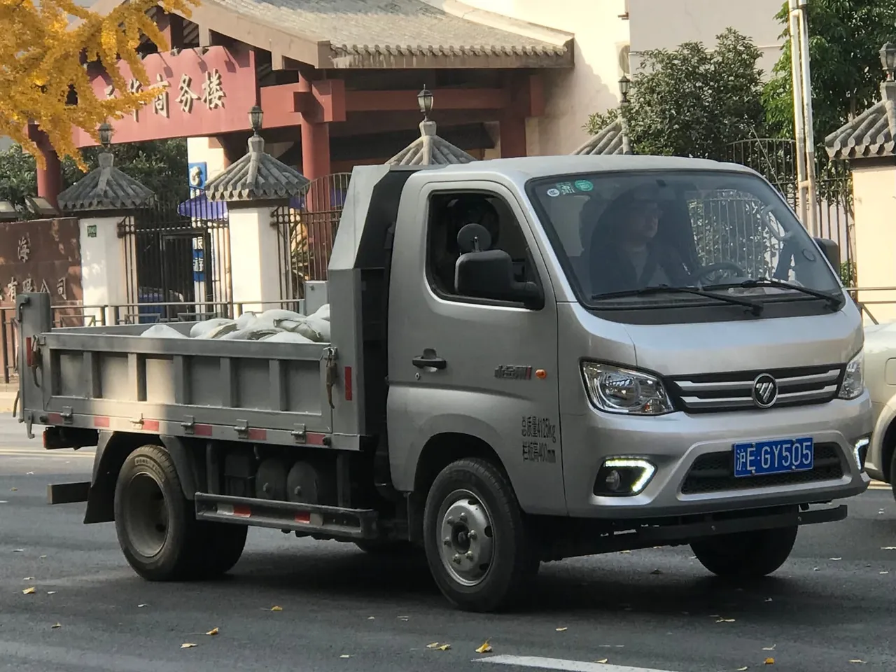 Used 2 ton dump truck with raised tipper body, ready for export